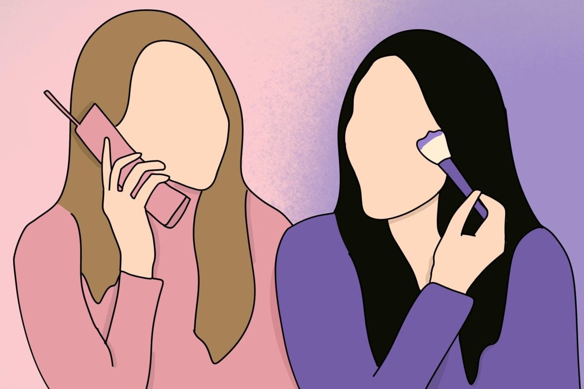 Two people in front of a dual-toned background, one with a phone and one with a makeup brush.