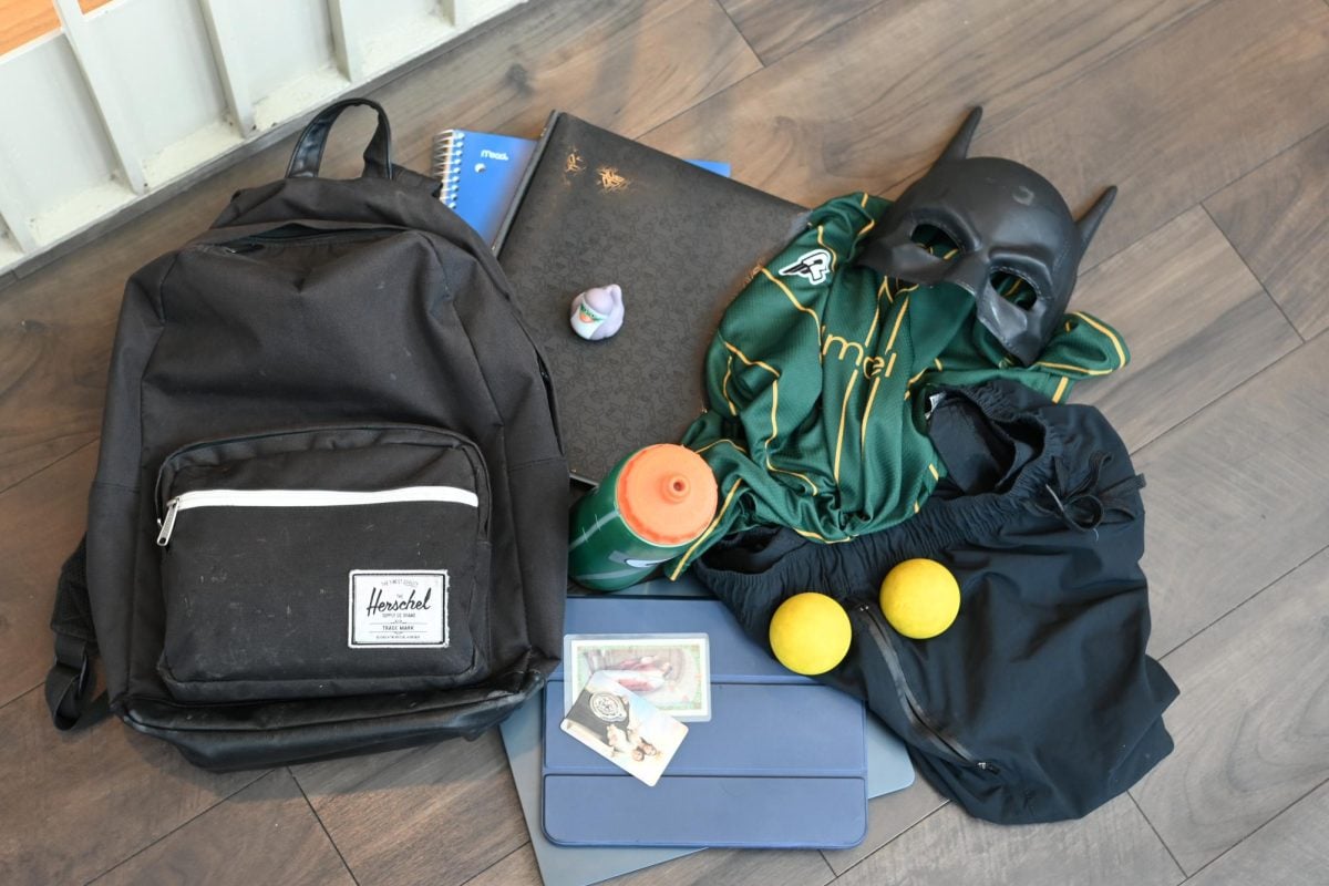 McCormick first-year Diego Claure’s backpack contains gym clothes, notebooks, prayer cards, lacrosse balls and a Batman mask. Claure said the items reflect his daily routine and personality.