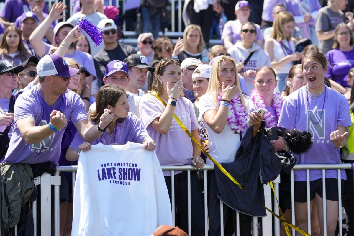 Fans in purple fill the stands.