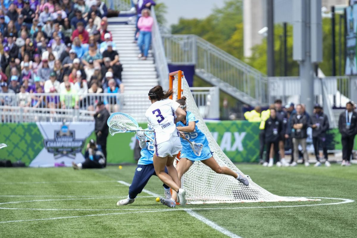 A player in white moves toward the goal.