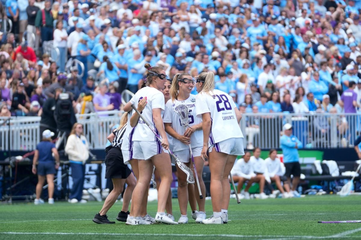 Players in white huddle on the field.