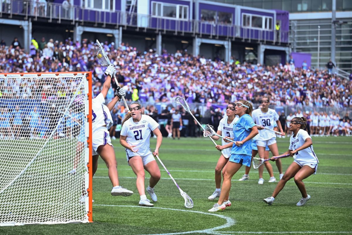 A goalie in white blocks a shot.