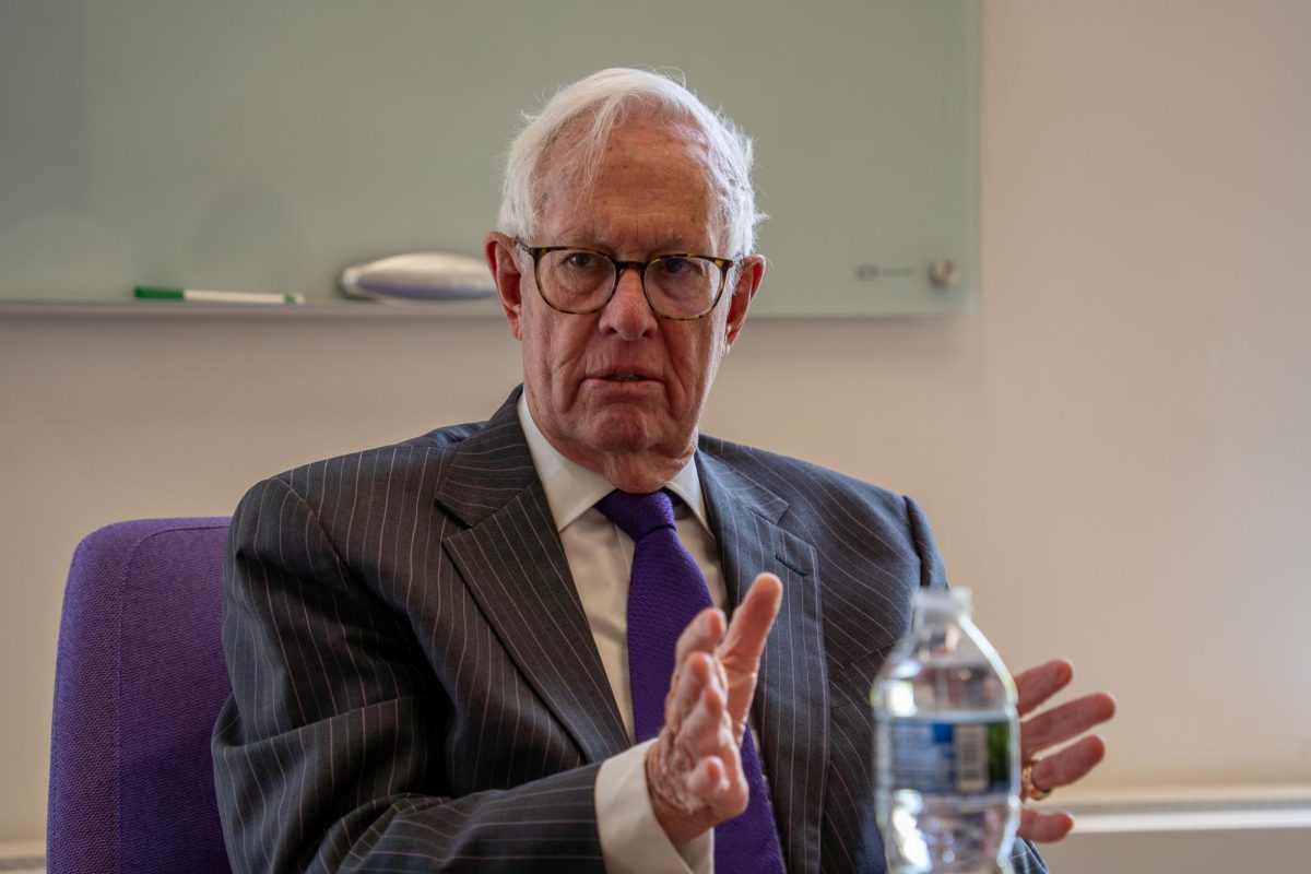 President Bienen speaks while sitting at a table. 