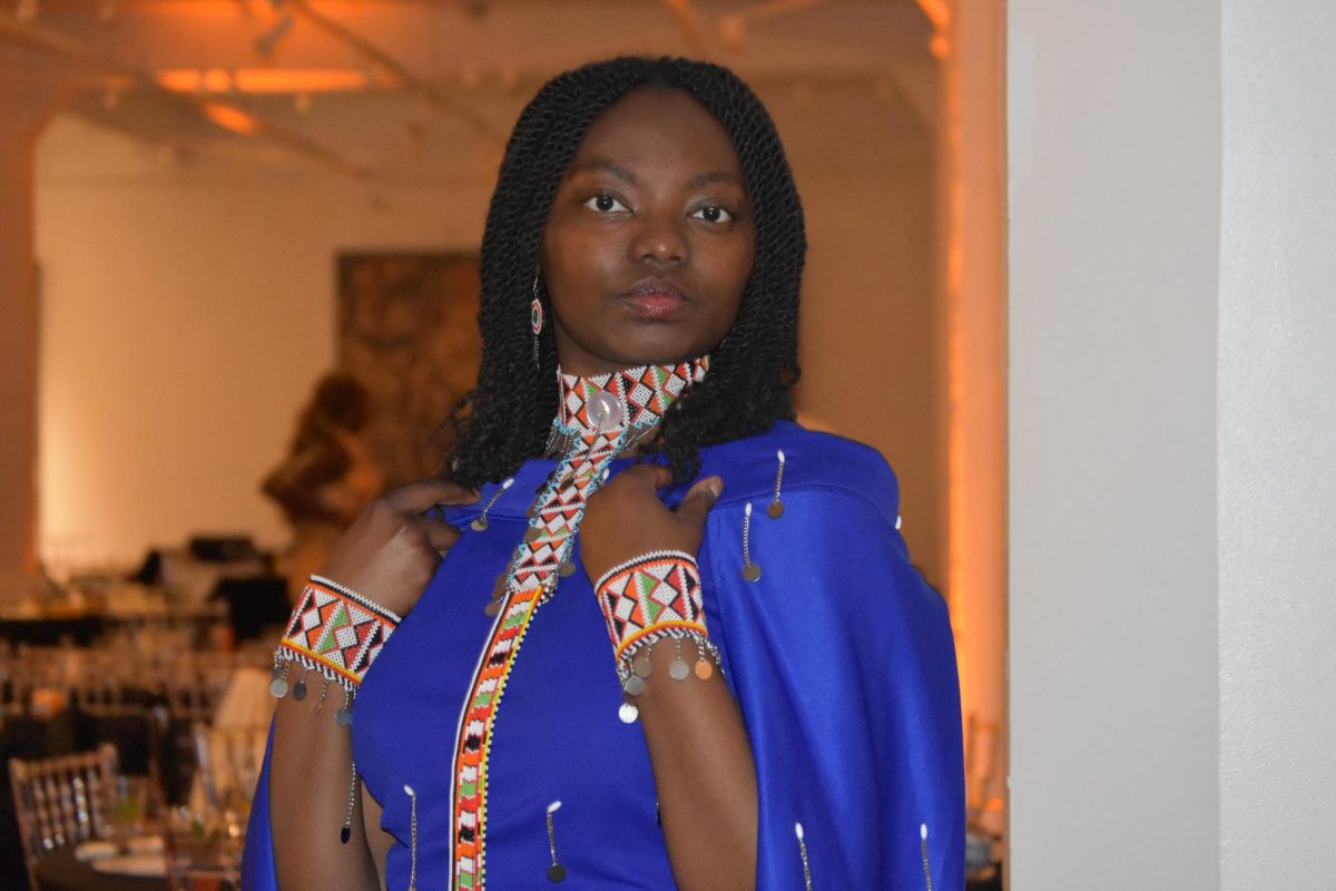 Girl in blue gown stands and poses.
