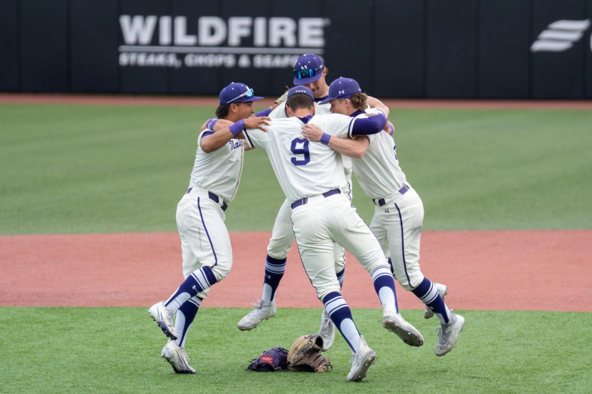 Four baseball players jump in the air together.