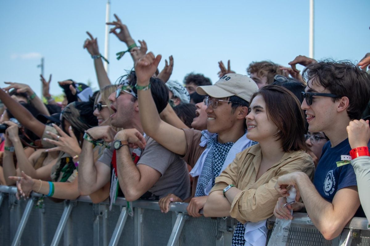 A group of people standing with their hands in the air.