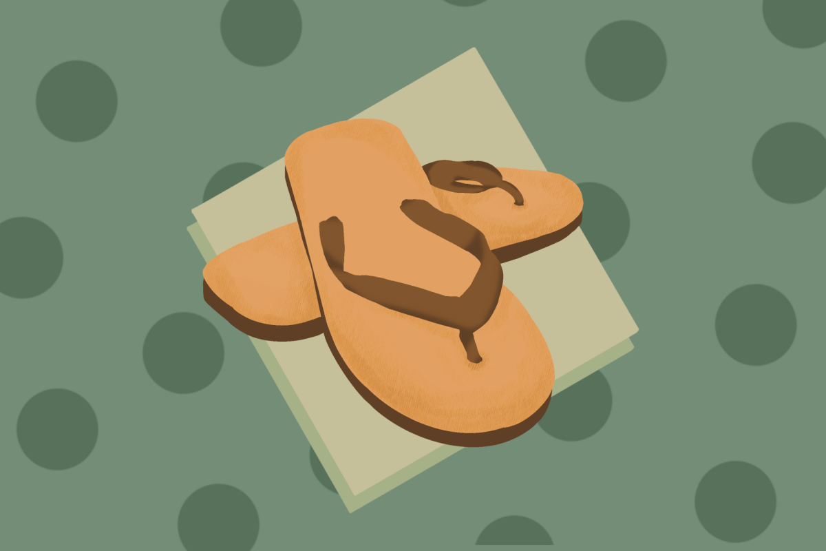 A pair of brown flip flops against a green polka-dot background.