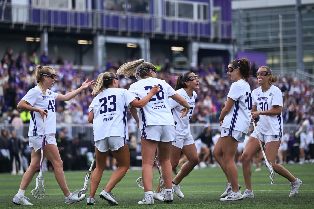 Players in white jerseys huddle together in celebration.