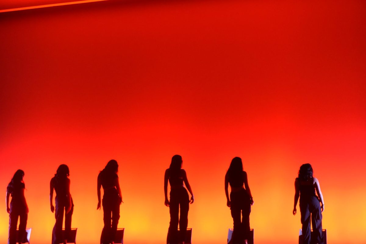 A group of people standing on chairs