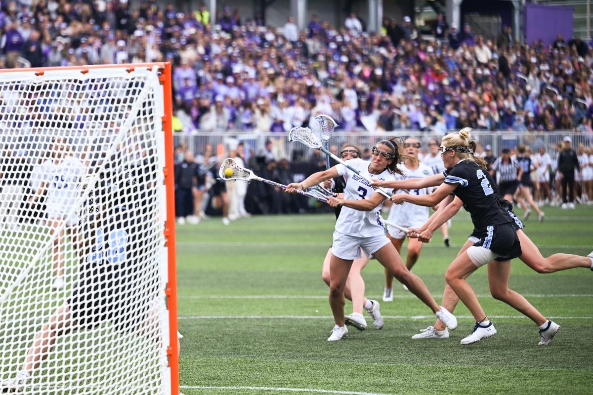 Players in black and white run toward a goal.