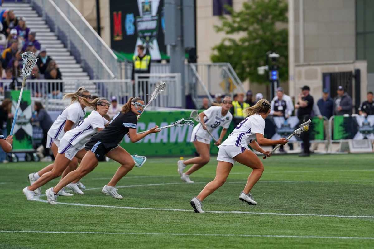 Players run after each other on a field.