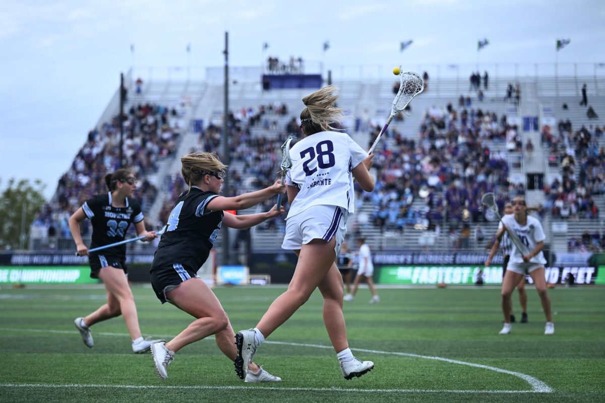 Players in black and white fight for a ball.