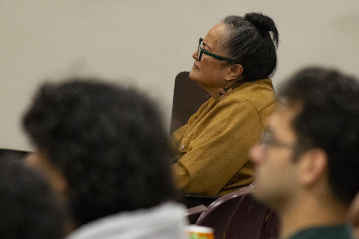 A person watches people perform.