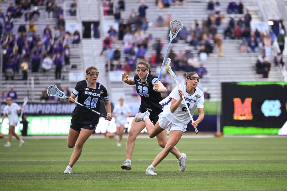 A player in white controls the ball while running from players in black.