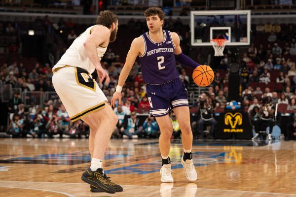 A basketball player dribbles the ball down the court.