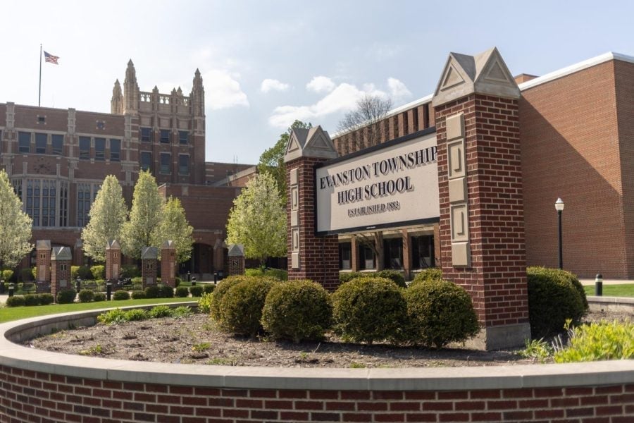A building with a sign that reads, “Evanston Township High School.”