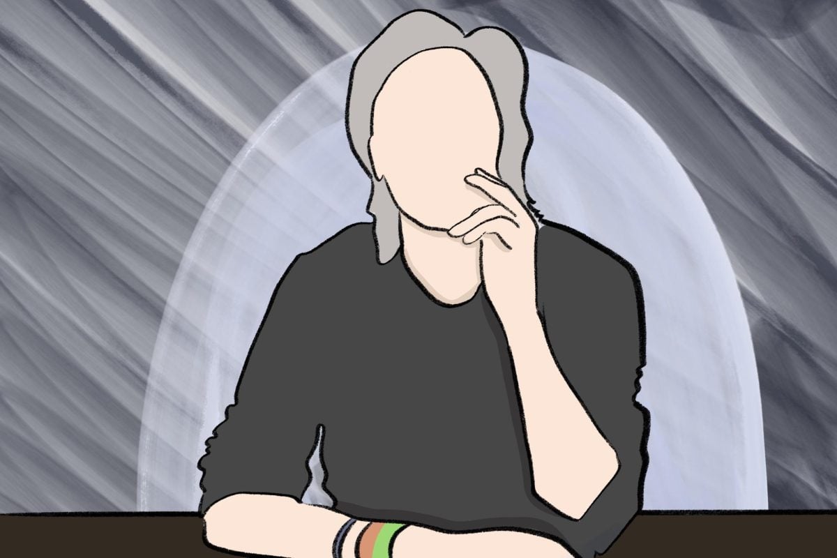 A person rests their chin on their hand.
