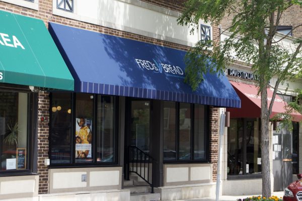 A storefront with a blue awning that reads “Fred’s Bread.”