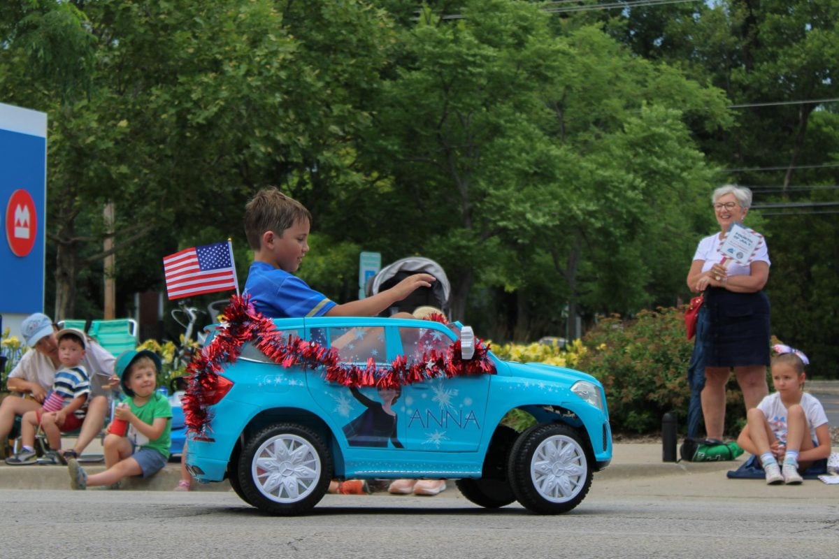 A child sits in a toy car