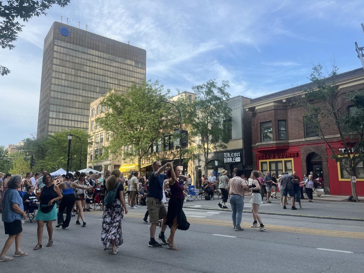 A crowd of people dancing in the street.