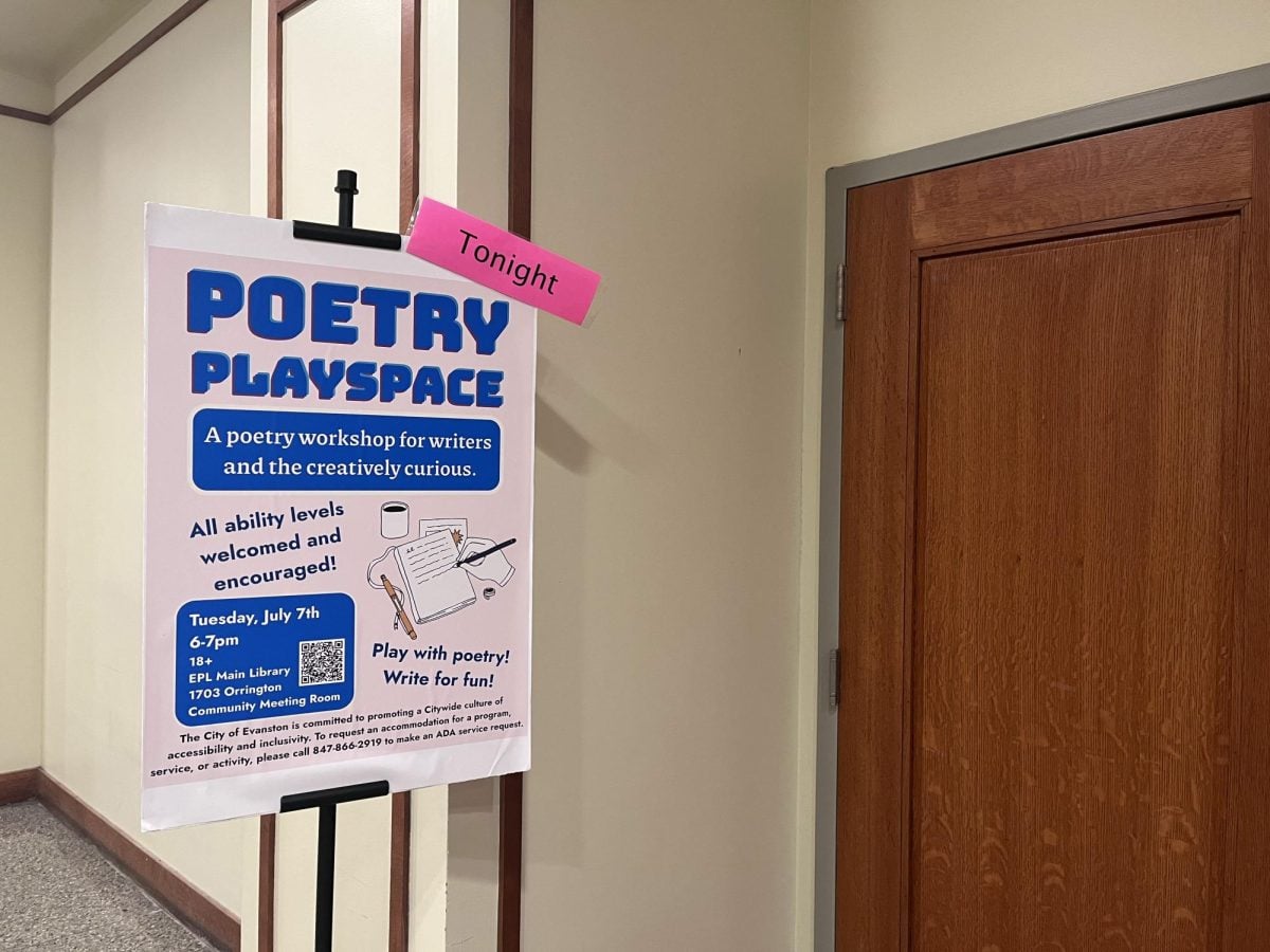 Sign outside of a room inviting people to the “Poetry Playspace” event.