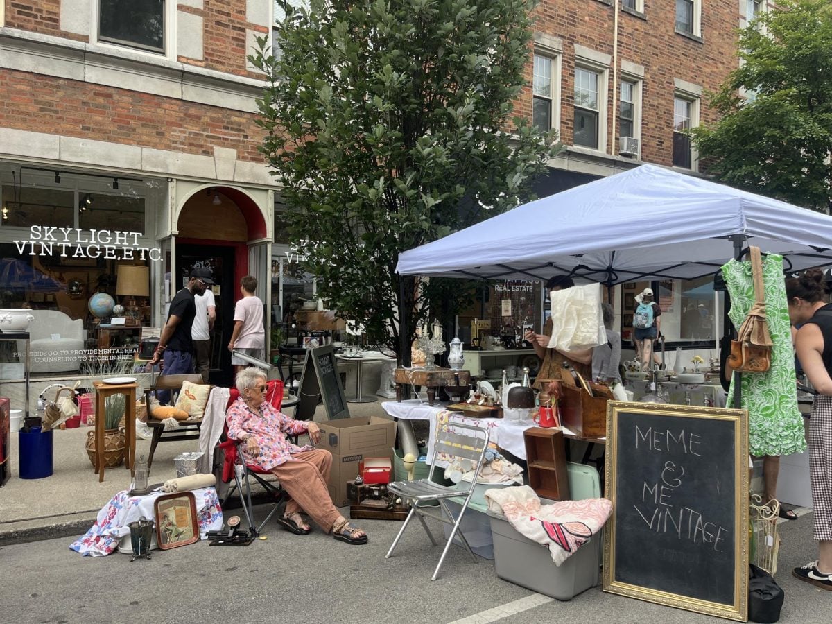 A tent surrounded by vintage items in front of a store.