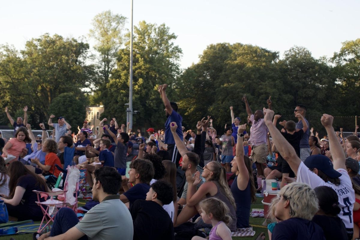 A crowd of people cheer