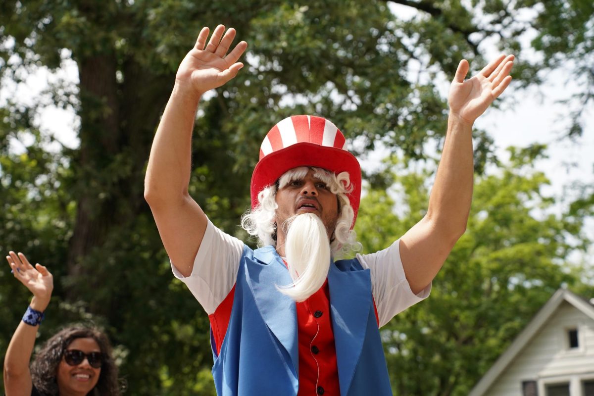 A participant dressed as Uncle Sam waves to the crowd