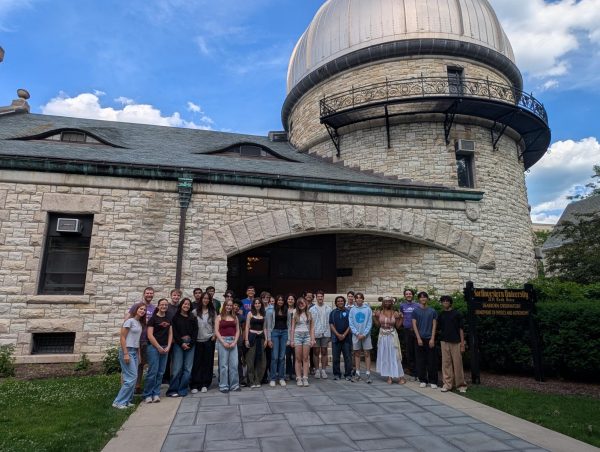 A group of over 20 people stand in front of Northwestern’s Dearborn Observatory