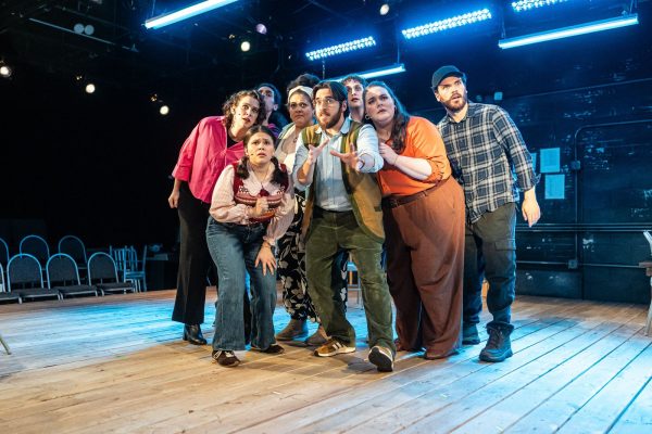 A group of people huddled together on stage.