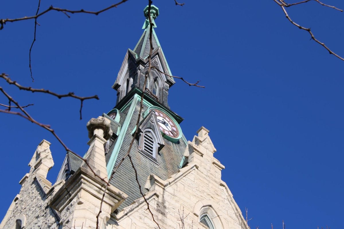 A photo of University Hall in front of a striking blue sky.
