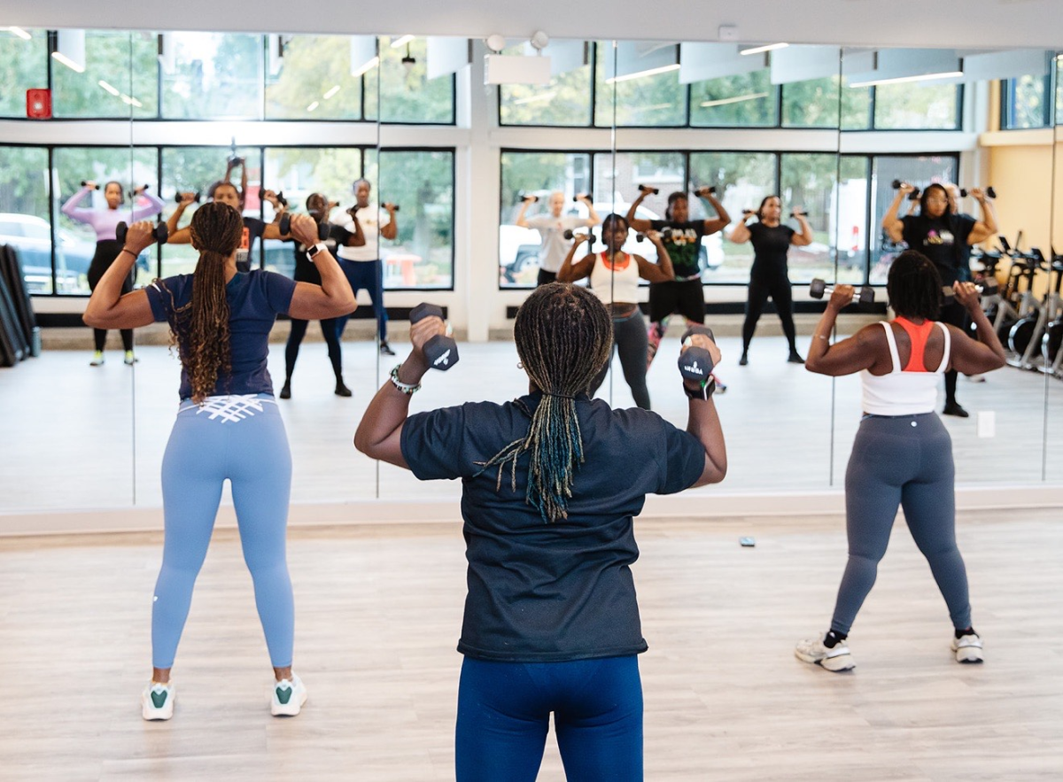 Group of people lifting weights in fitness class