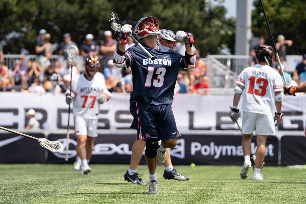 A player in a dark blue jersey celebrates after a goal.