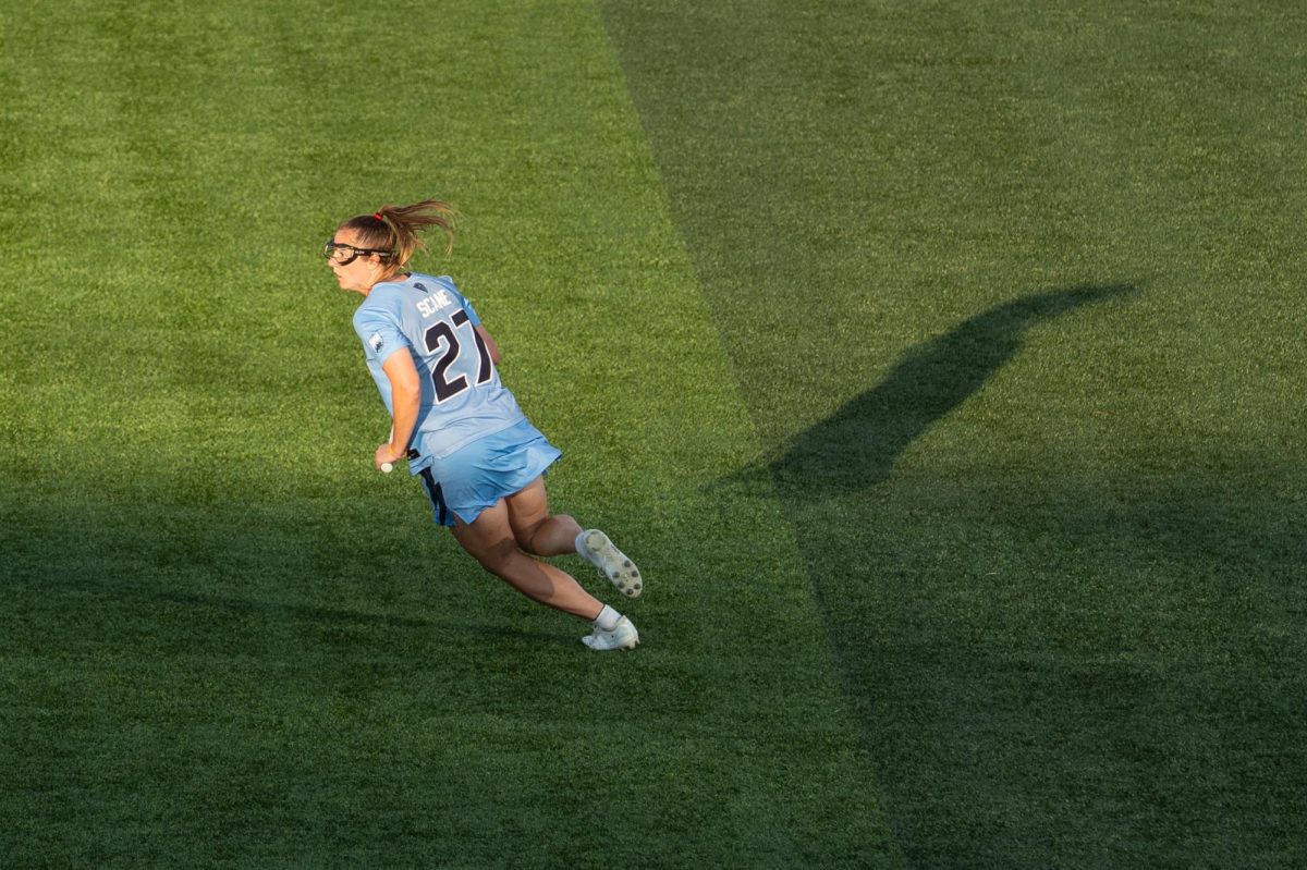 A player in a blue jersey surveys the field. 