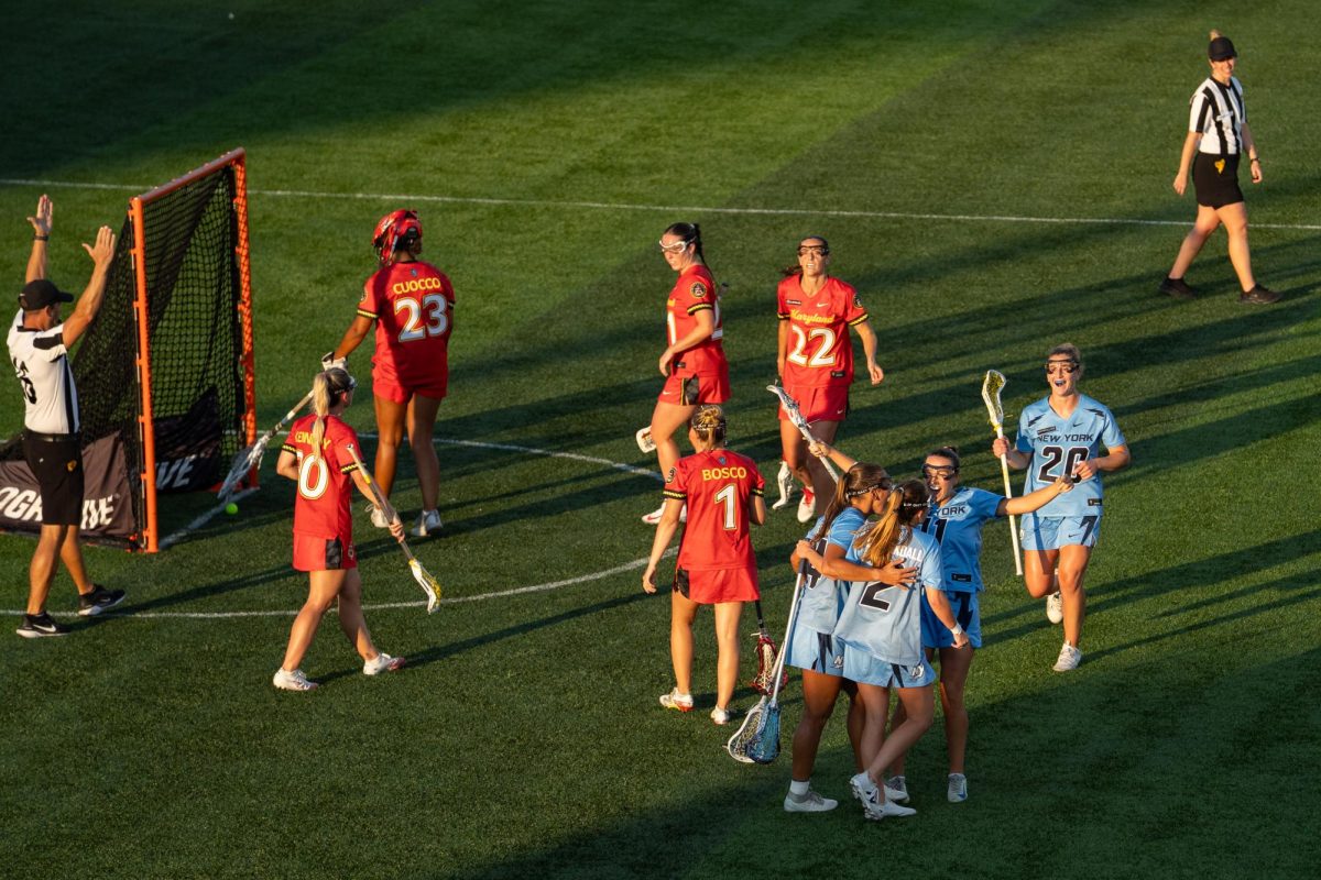 Players in blue jerseys celebrate after a goal.
