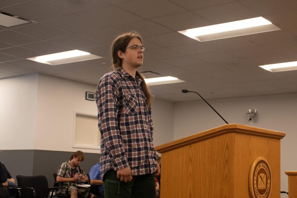 A person stands behind a lectern.