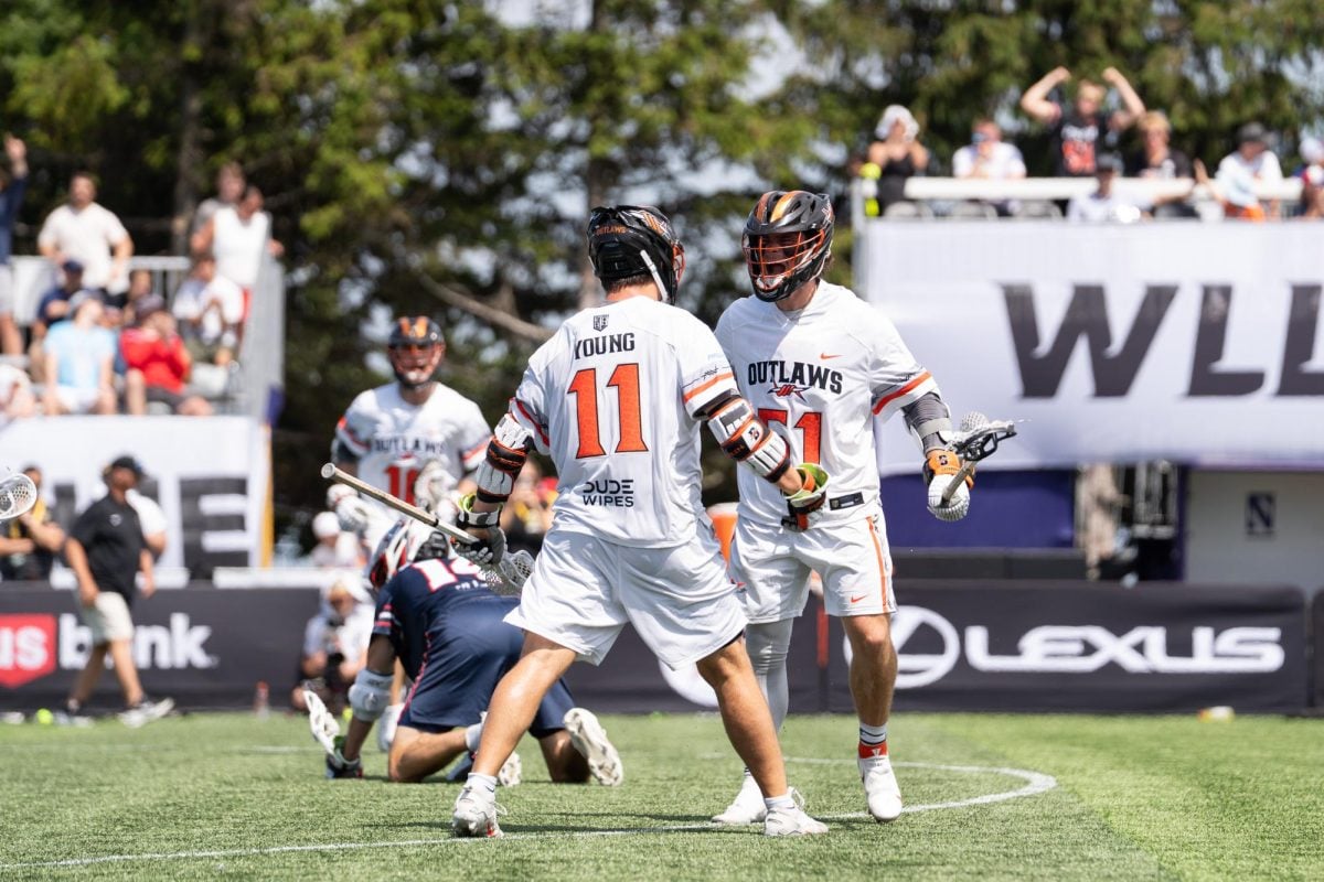 Two players in white jerseys celebrate after a goal.