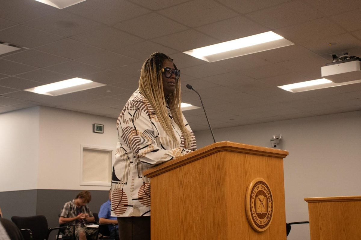 A person stands behind a lectern.